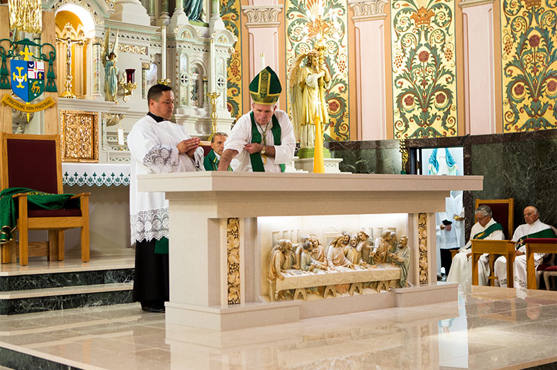 Bishop O'Connell Consecrating altar